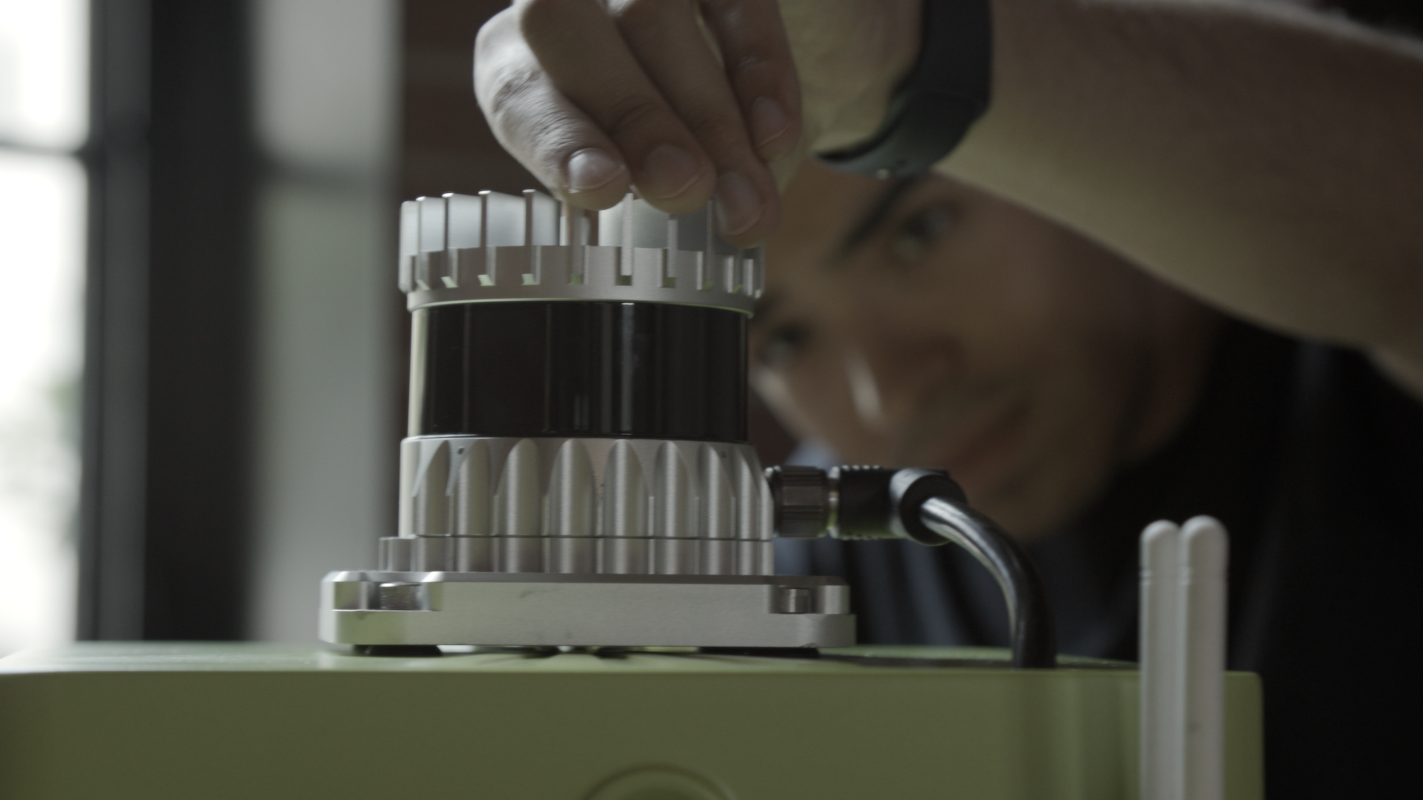 Daniel Pelaez adjusting a lidar sensor on a Cyvl rig
